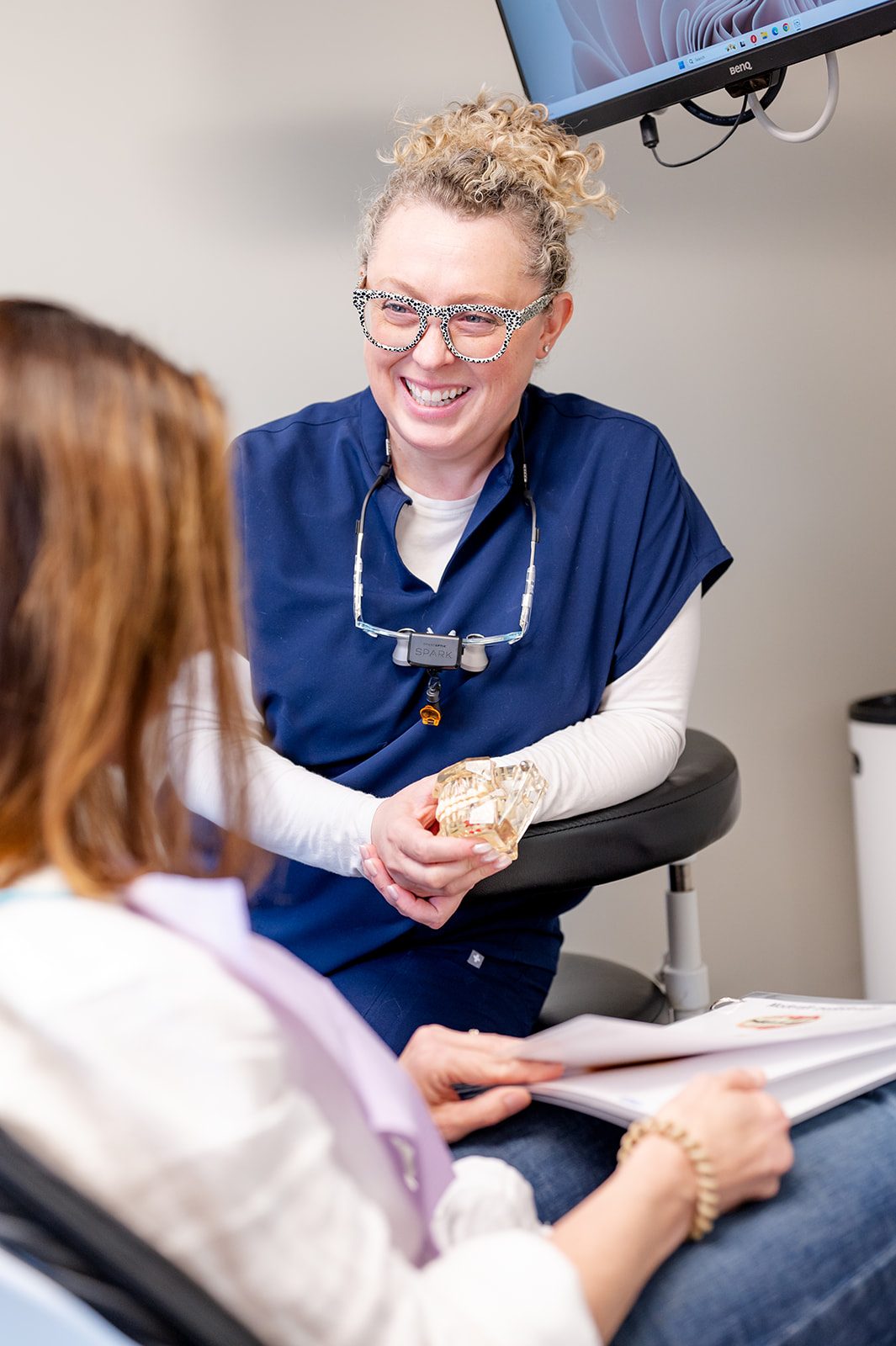A dentist discussing denture options with a patient