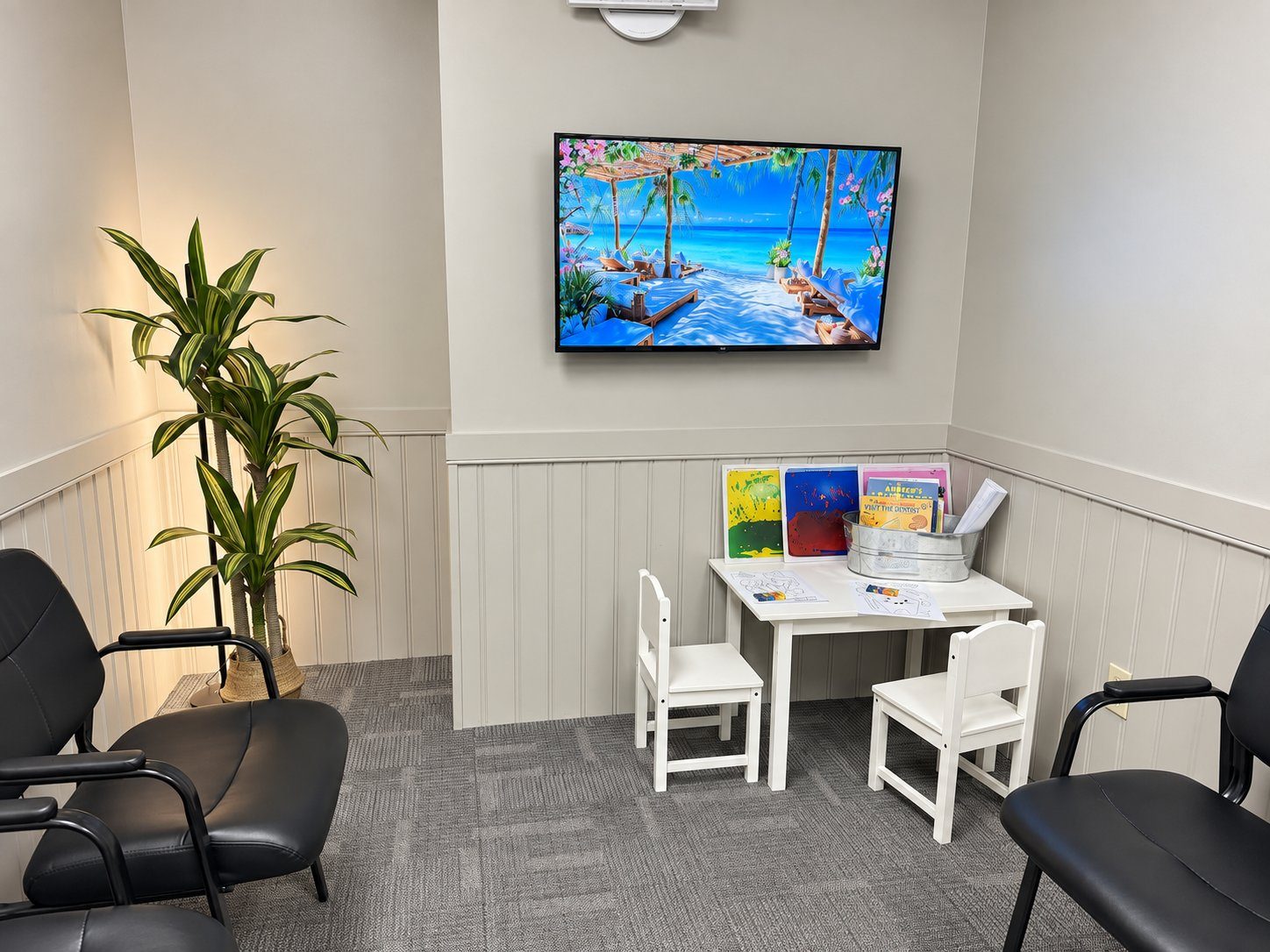 The children's corner in our South London waiting room, with a small table, books, and colouring pages