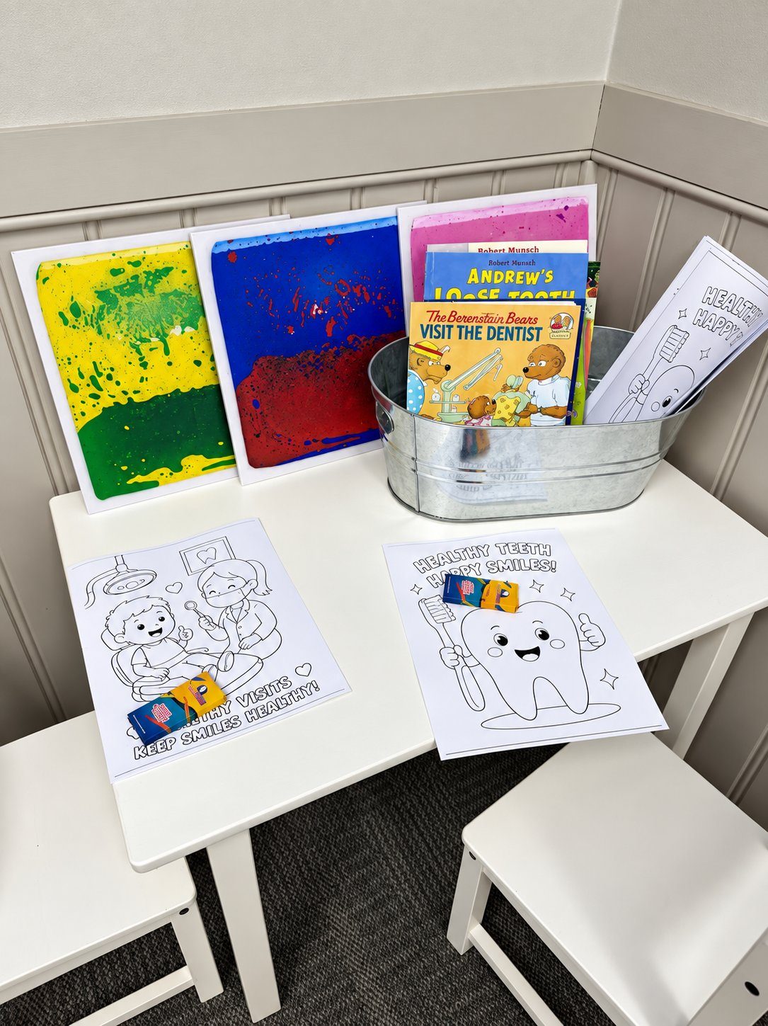 A close look at the kids table with colouring pages, books, and colourful activity boards