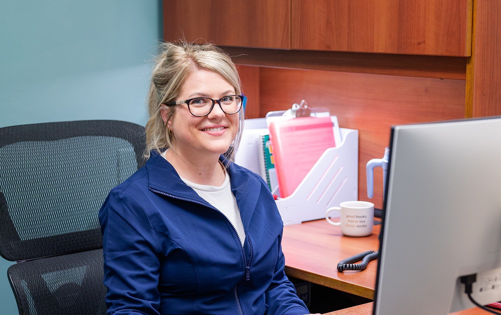 A team member at the desk, ready to help with questions about care
