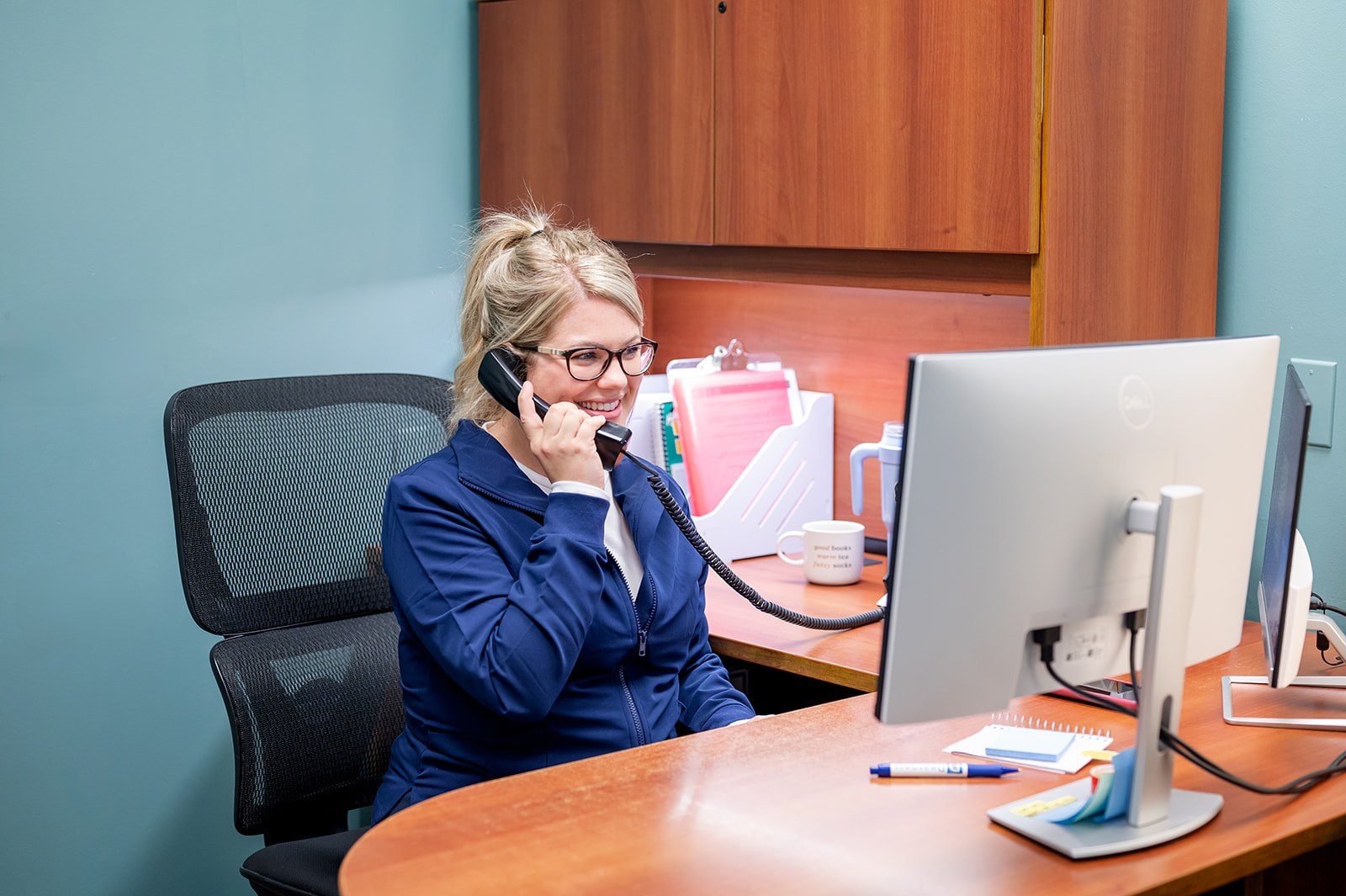 A team member answering the phone at Dearness Family Dentistry