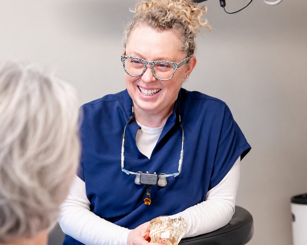 A dentist talking through treatment options with a senior patient during an unhurried visit