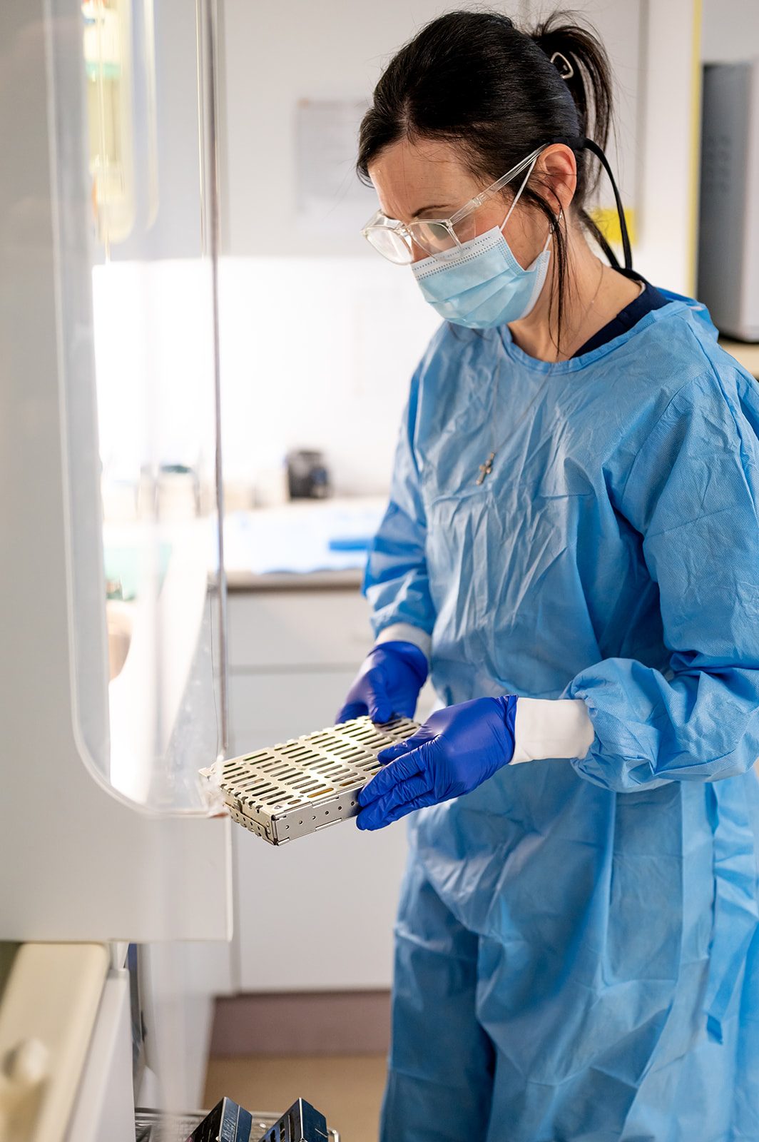 A team member following sterilization protocol between patients