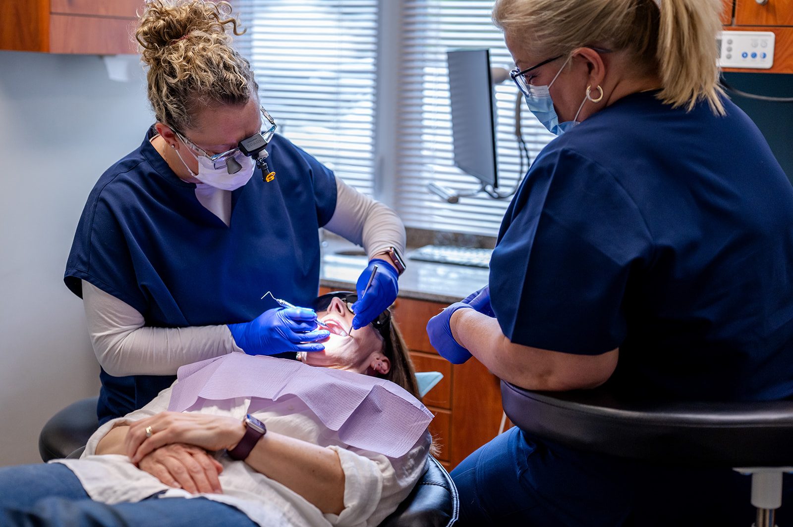 A dentist and assistant providing treatment in the operatory